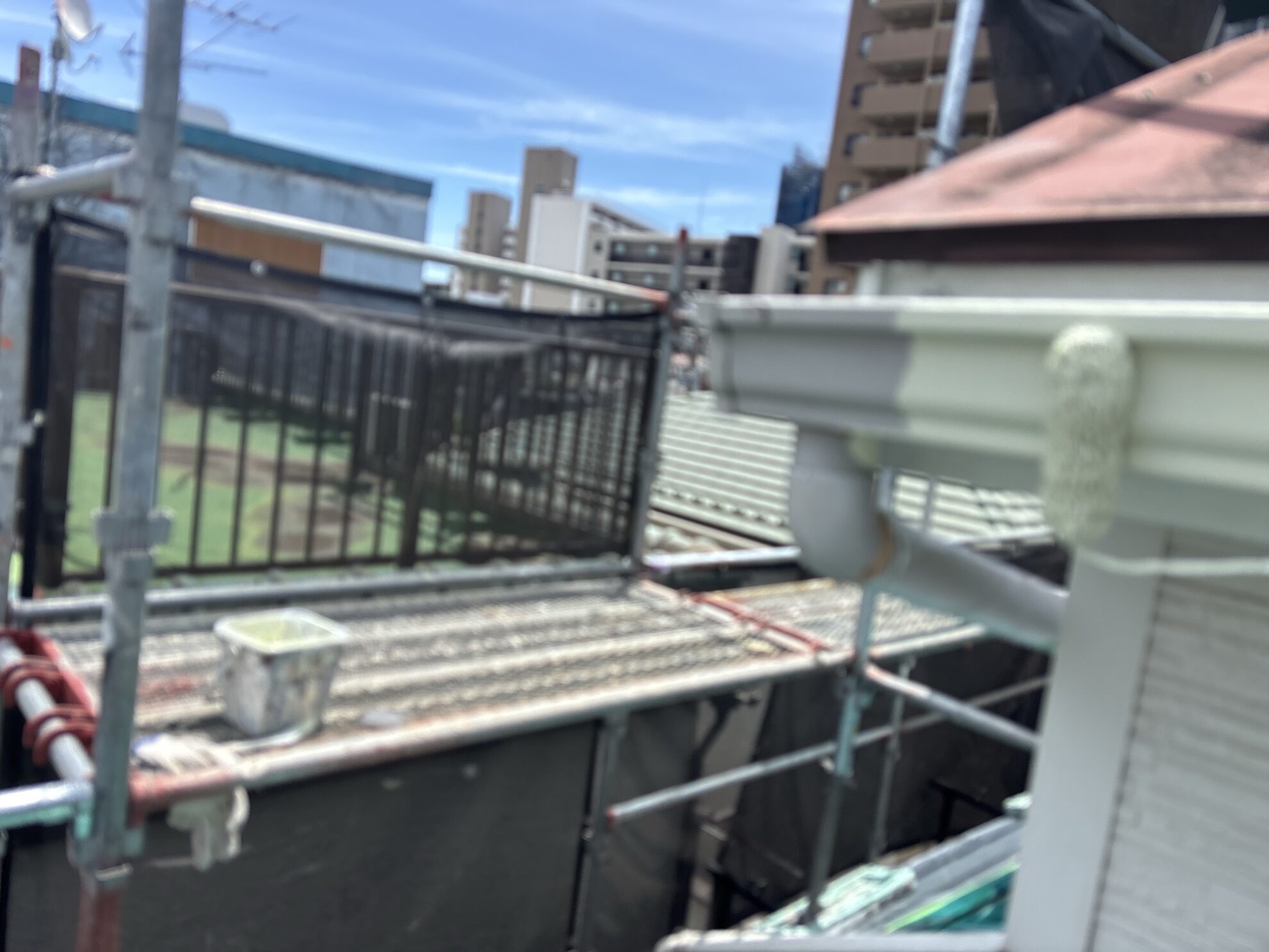 羽村市U様邸で雨樋に中塗りを行っている様子